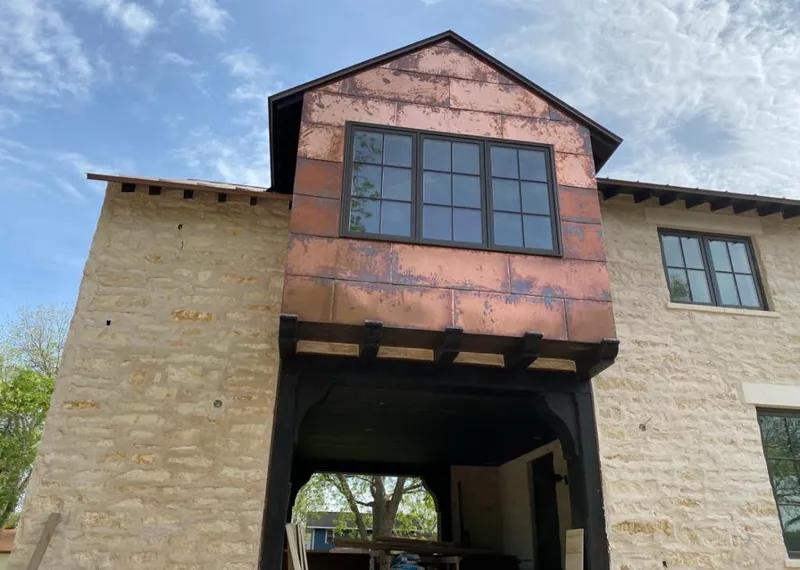 Copper metal panel facade on a stone building for Skylight Installation in Stevens Point