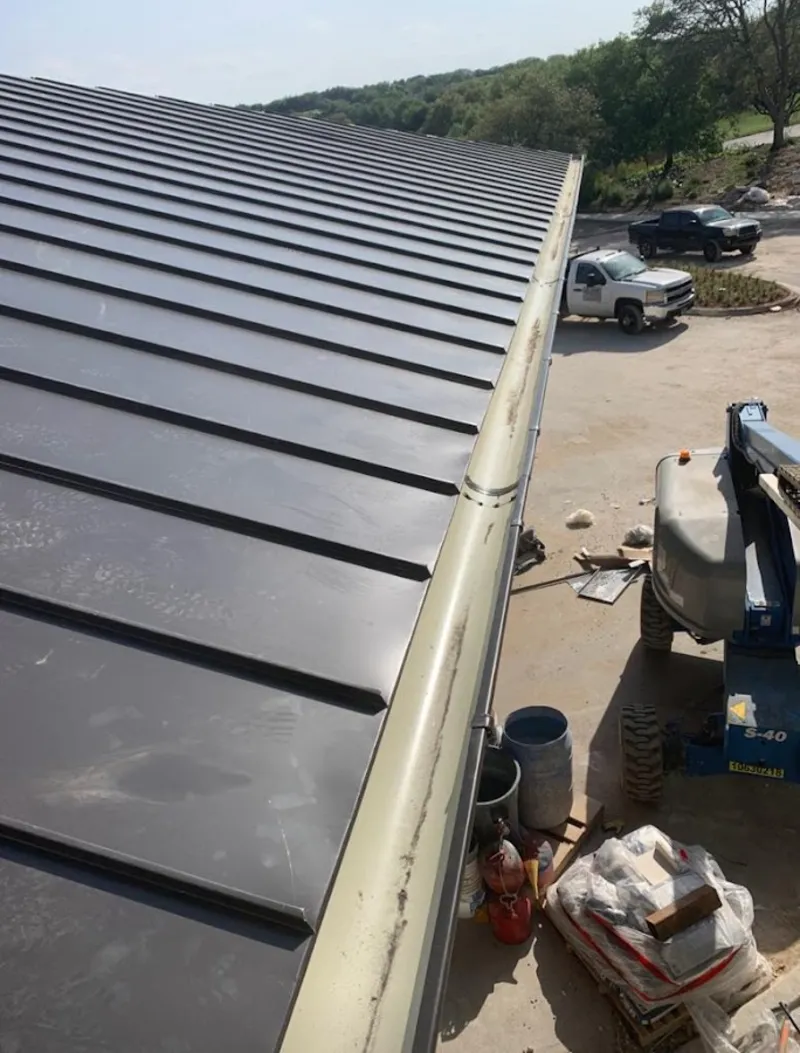 Standing seam panel and gutter detail on a metal roofing jobsite in Stevens Point